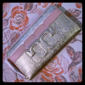 Gold + pink quartz Tory Burch multifold zip wallet